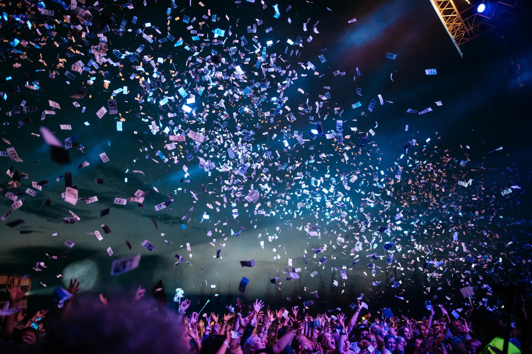 Concert crowd illuminated by colorful lights at a live event