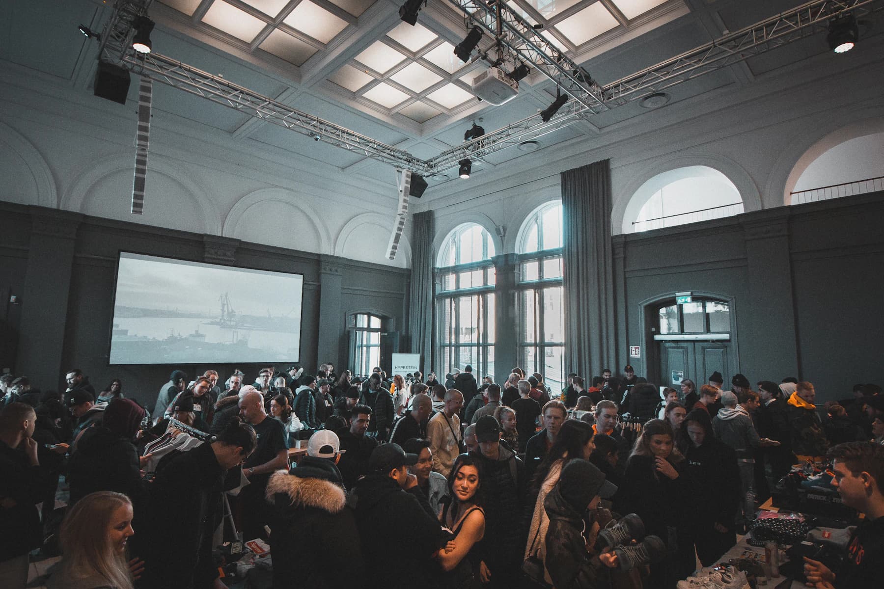 People socializing at an indoor event with warm ambient lighting